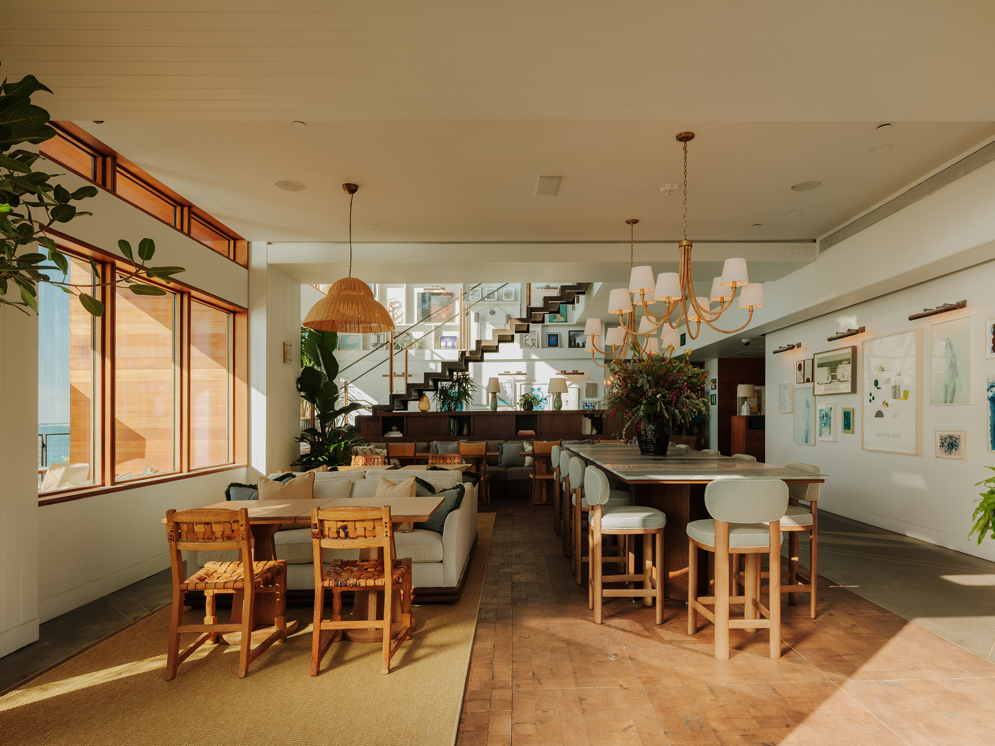 Sunlit lounge and art collection inside Little Beach House Malibu